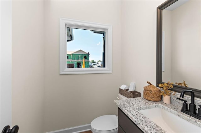 20714 Emerald St, Spring Hill, KS 66030 - half bathroom with vanity, toilet, and baseboards