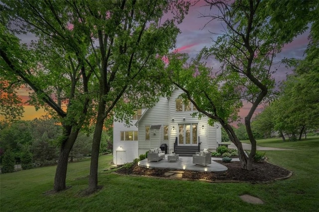7007 Bell Rd, Shawnee, KS 66217 - back of property at dusk featuring a patio area, a yard, and french doors