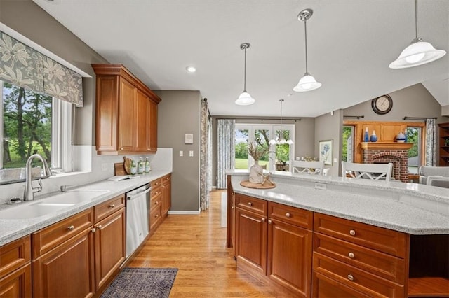 7007 Bell Rd, Shawnee, KS 66217 - kitchen with a sink, dishwasher, light wood-style floors, pendant lighting, and brown cabinetry