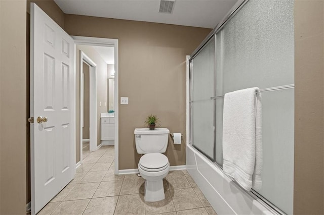 7007 Bell Rd, Shawnee, KS 66217 - full bathroom with toilet, enclosed tub / shower combo, tile patterned flooring, and baseboards