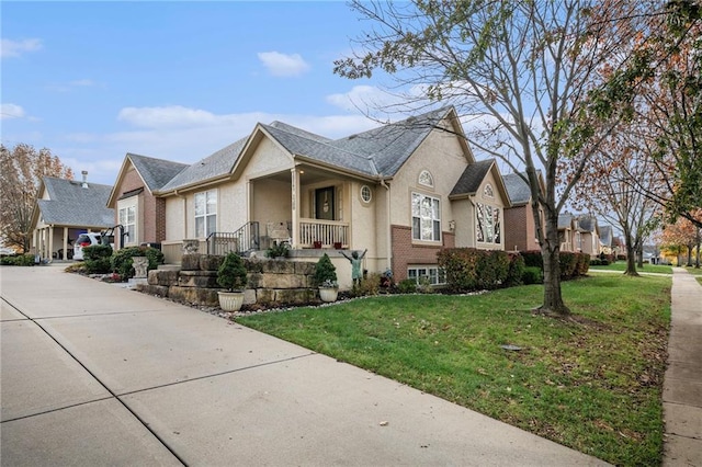 15141 S Symphony Dr Unit 1300, Olathe, KS 66062 - view of front facade featuring covered porch, a front yard, a residential view, and stucco siding