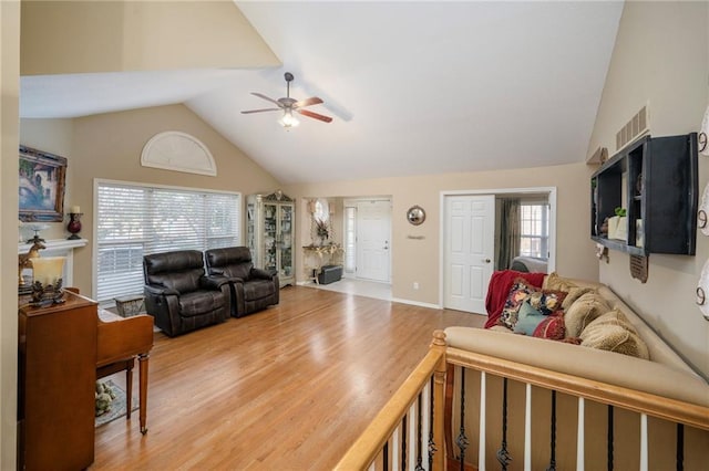 15141 S Symphony Dr Unit 1300, Olathe, KS 66062 - living room with a ceiling fan, wood finished floors, and high vaulted ceiling