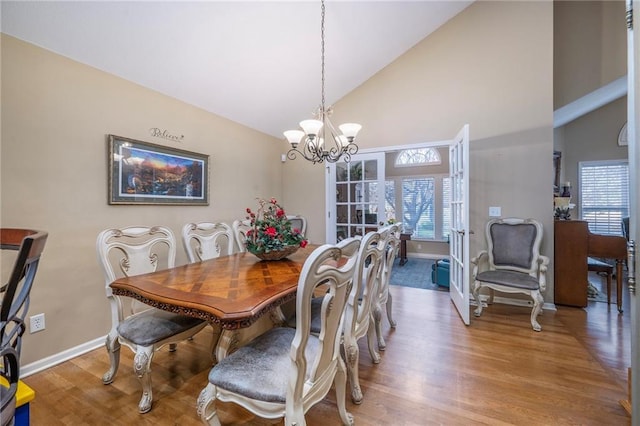 15141 S Symphony Dr Unit 1300, Olathe, KS 66062 - dining room featuring high vaulted ceiling, wood finished floors, a chandelier, baseboards, and french doors