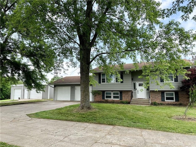 609 N Broadway St, Knob Noster, MO 65336 - view of front of home with concrete driveway, a front yard, and brick siding