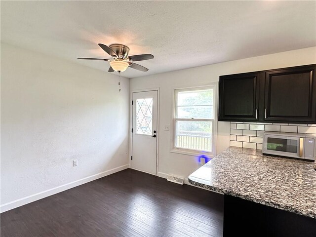 609 N Broadway St, Knob Noster, MO 65336 - kitchen featuring stainless steel microwave, baseboards, ceiling fan, and dark wood-style floors