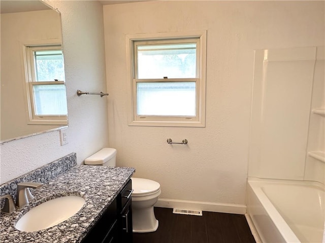 609 N Broadway St, Knob Noster, MO 65336 - full bathroom with vanity, toilet, wood finished floors, and baseboards