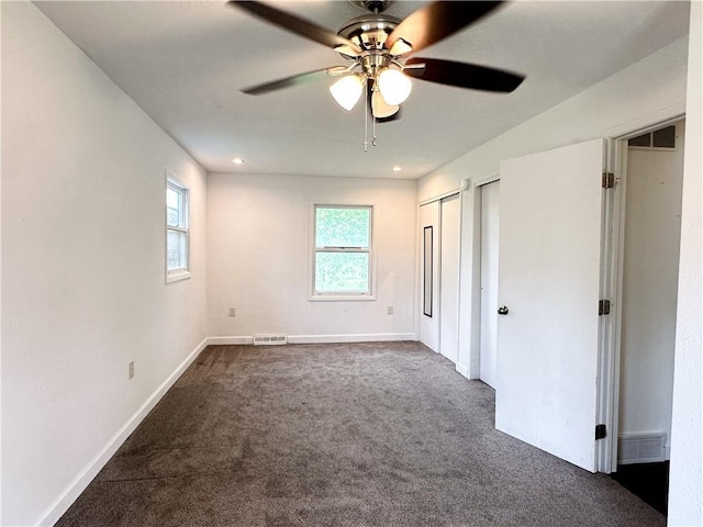 609 N Broadway St, Knob Noster, MO 65336 - unfurnished bedroom featuring dark colored carpet, baseboards, and a ceiling fan