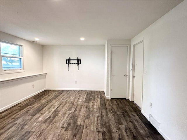 609 N Broadway St, Knob Noster, MO 65336 - unfurnished room featuring dark wood-type flooring, baseboards, and recessed lighting