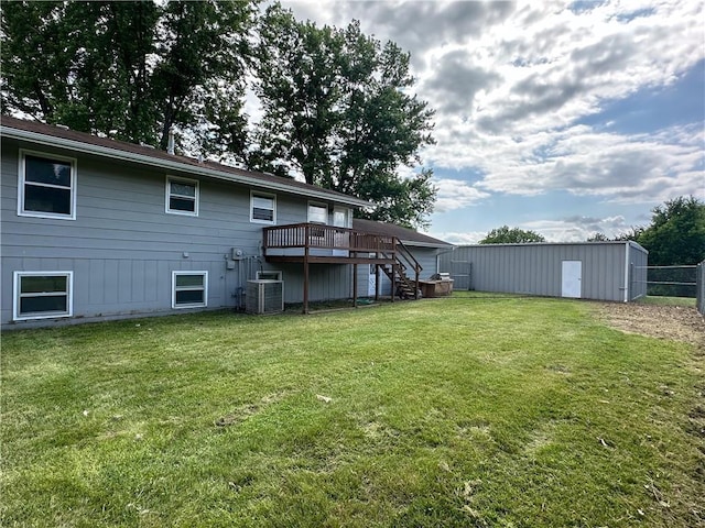 609 N Broadway St, Knob Noster, MO 65336 - rear view of property featuring central air condition unit, a deck, stairway, and an outdoor structure