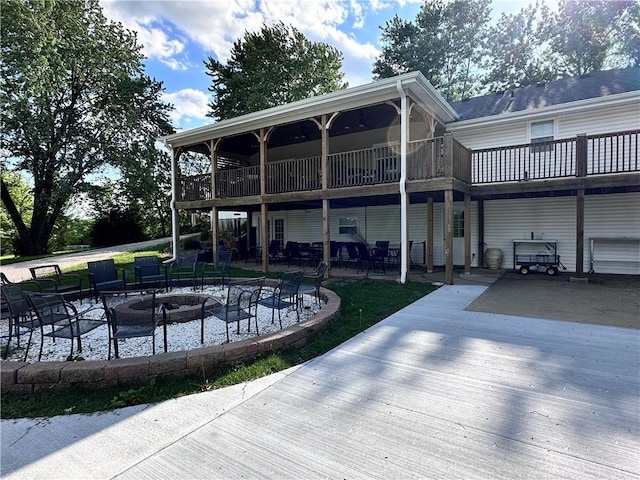 14409 Tillman Rd, Smithville, MO 64089 - rear view of property featuring an outdoor fire pit, a patio area, and a deck