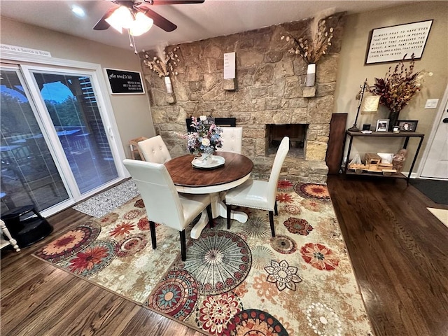 14409 Tillman Rd, Smithville, MO 64089 - dining area with wood finished floors, ceiling fan, and a fireplace