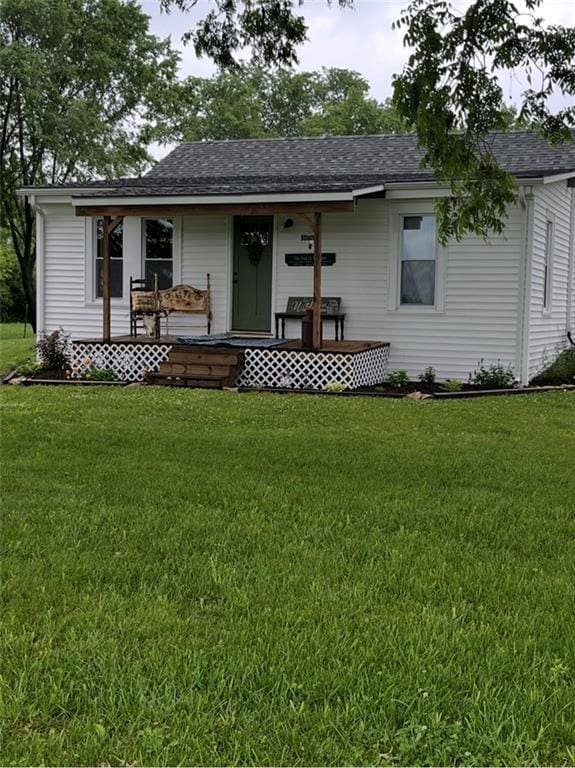 1596 Haskell Rd, Williamsburg, KS 66095 - view of front of house with covered porch, a front yard, and a shingled roof