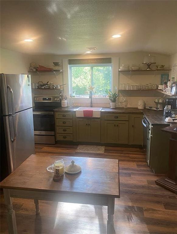 1596 Haskell Rd, Williamsburg, KS 66095 - kitchen featuring a sink, appliances with stainless steel finishes, dark wood-style floors, dark countertops, and vaulted ceiling