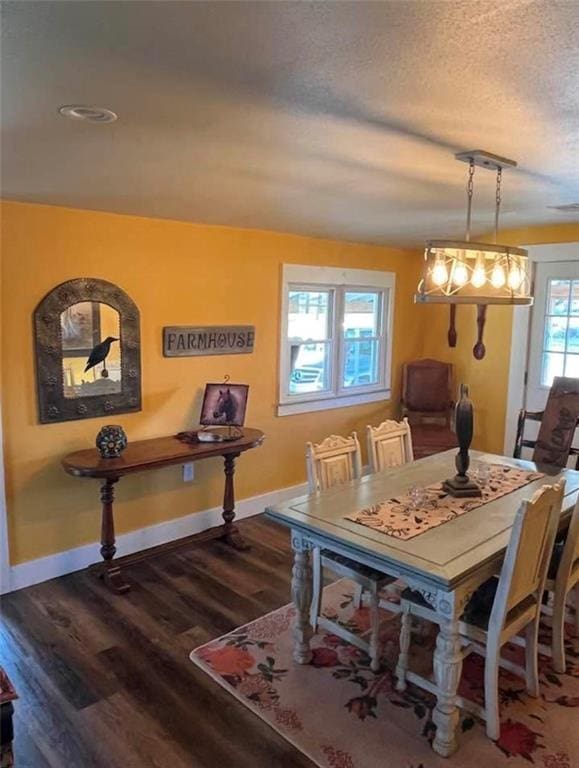 1596 Haskell Rd, Williamsburg, KS 66095 - dining space with wood finished floors, baseboards, and a textured ceiling