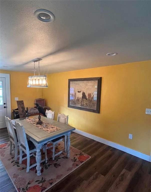 1596 Haskell Rd, Williamsburg, KS 66095 - dining space featuring baseboards, dark wood-style floors, and a textured ceiling