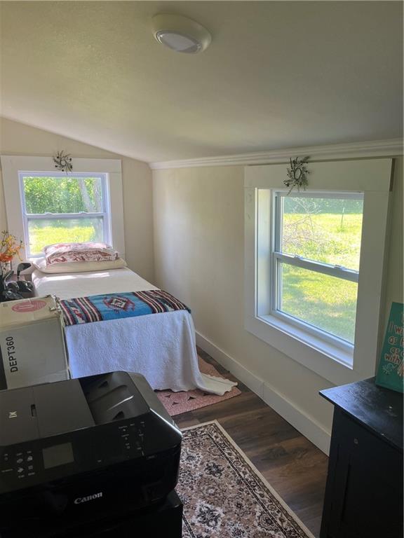 1596 Haskell Rd, Williamsburg, KS 66095 - bedroom featuring multiple windows, wood finished floors, baseboards, lofted ceiling, and crown molding