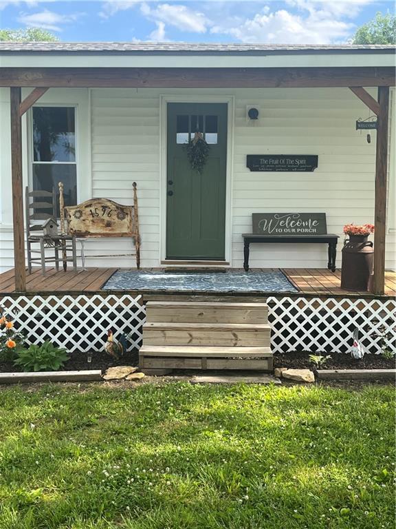 1596 Haskell Rd, Williamsburg, KS 66095 - view of exterior entry with a porch and a lawn