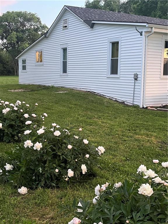 1596 Haskell Rd, Williamsburg, KS 66095 - view of side of property featuring roof with shingles and a yard