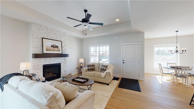 15595 N Sheridan Ct, Basehor, KS 66007 - living area with a tray ceiling, light wood-style floors, a chandelier, plenty of natural light, and recessed lighting