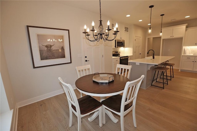 15595 N Sheridan Ct, Basehor, KS 66007 - dining room featuring light wood-style flooring, a chandelier, recessed lighting, and baseboards