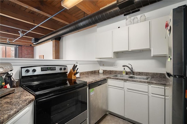 700 Broadway Blvd Unit 210, Kansas City, MO 64105 - kitchen with stainless steel appliances, a sink, white cabinetry, and dark countertops