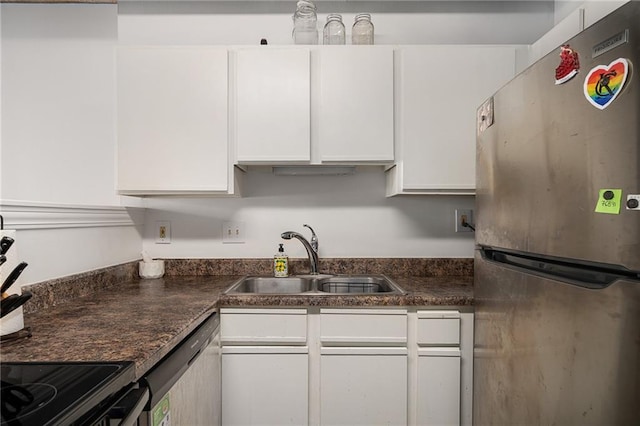 700 Broadway Blvd Unit 210, Kansas City, MO 64105 - kitchen with stainless steel appliances, a sink, white cabinets, and dark countertops