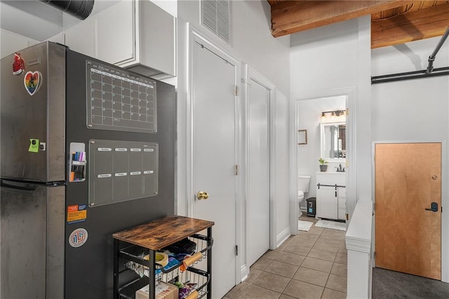 700 Broadway Blvd Unit 210, Kansas City, MO 64105 - kitchen featuring light tile patterned flooring, white cabinetry, heating unit, and mail area