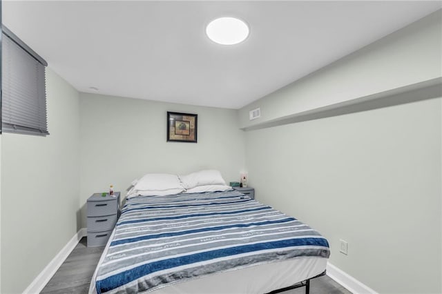 2831 E 8th St, Kansas City, MO 64124 - bedroom featuring baseboards and wood finished floors