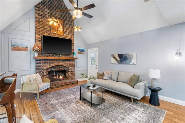 16011 W 149th Ter, Olathe, KS 66062 - living area with lofted ceiling, a ceiling fan, wood finished floors, and a fireplace