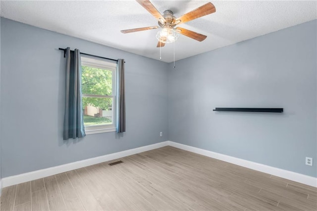 16011 W 149th Ter, Olathe, KS 66062 - unfurnished room featuring wood finished floors, a textured ceiling, and ceiling fan