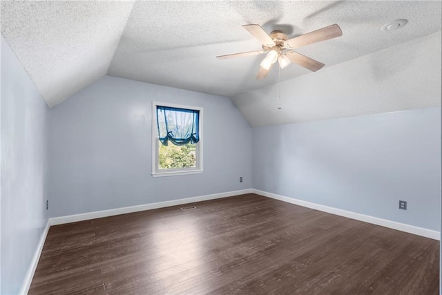16011 W 149th Ter, Olathe, KS 66062 - additional living space featuring vaulted ceiling, dark wood-style flooring, a textured ceiling, and ceiling fan