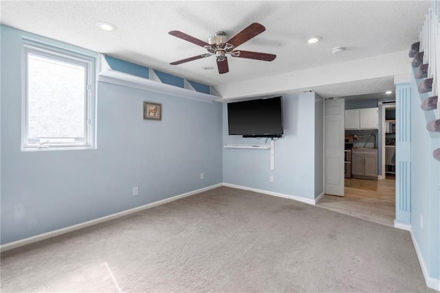 16011 W 149th Ter, Olathe, KS 66062 - unfurnished living room featuring light carpet, a ceiling fan, a textured ceiling, and recessed lighting