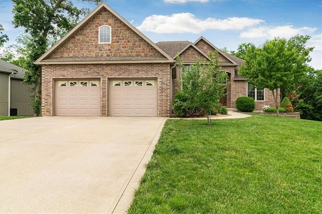 906 Cheatham Ct, Warrensburg, MO 64093 - view of front facade with driveway, a front lawn, and brick siding