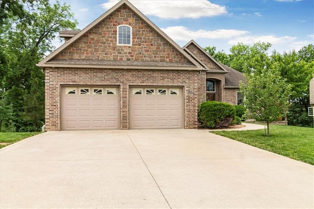 906 Cheatham Ct, Warrensburg, MO 64093 - view of front facade featuring driveway, brick siding, a front lawn, and a garage