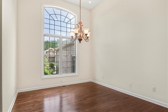 906 Cheatham Ct, Warrensburg, MO 64093 - unfurnished dining area with a chandelier, dark wood-style floors, and baseboards