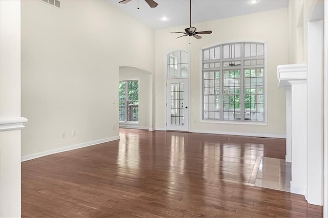 906 Cheatham Ct, Warrensburg, MO 64093 - unfurnished living room with ceiling fan, wood finished floors, baseboards, arched walkways, and recessed lighting