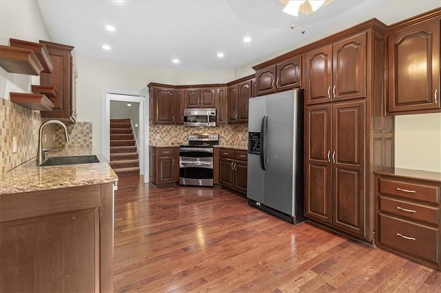 906 Cheatham Ct, Warrensburg, MO 64093 - kitchen featuring stainless steel appliances, a sink, dark wood-type flooring, tasteful backsplash, and recessed lighting