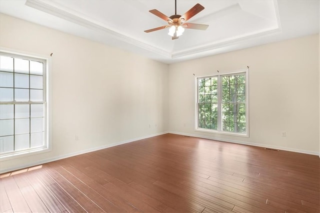 906 Cheatham Ct, Warrensburg, MO 64093 - spare room featuring a tray ceiling, ceiling fan, wood finished floors, and baseboards