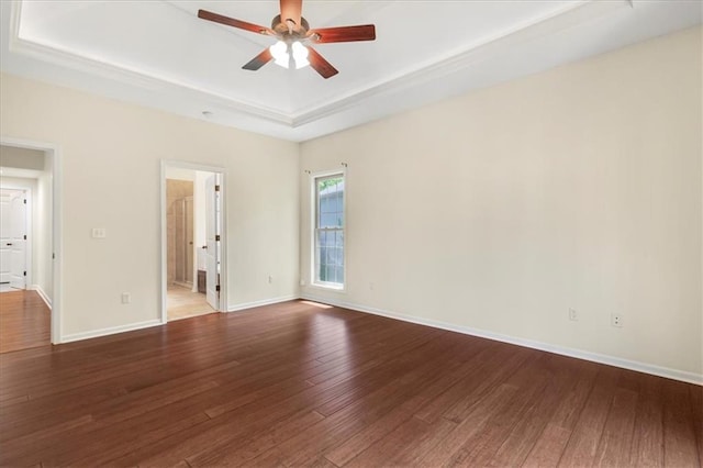 906 Cheatham Ct, Warrensburg, MO 64093 - spare room featuring a raised ceiling, ceiling fan, wood-type flooring, and baseboards