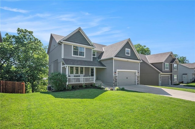 5021 NW Timberline Dr, Riverside, MO 64150 - craftsman-style house featuring a porch, concrete driveway, an attached garage, central air condition unit, and stone siding