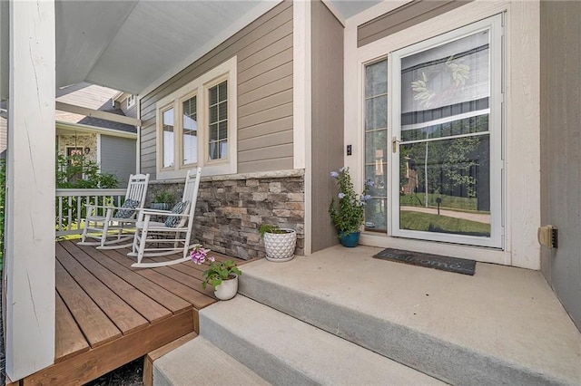 5021 NW Timberline Dr, Riverside, MO 64150 - view of exterior entry featuring a porch and stone siding