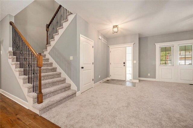 5021 NW Timberline Dr, Riverside, MO 64150 - carpeted entrance foyer with stairway and baseboards