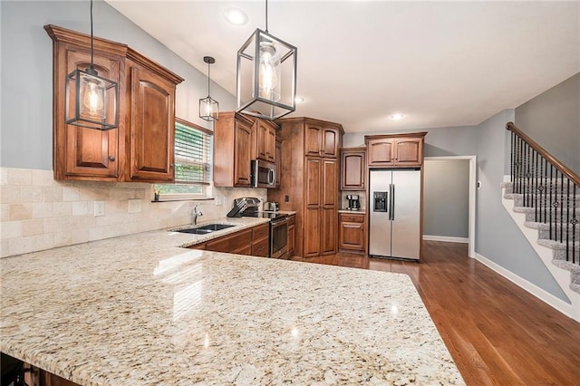 5021 NW Timberline Dr, Riverside, MO 64150 - kitchen featuring stainless steel appliances, a sink, decorative backsplash, light stone countertops, and recessed lighting