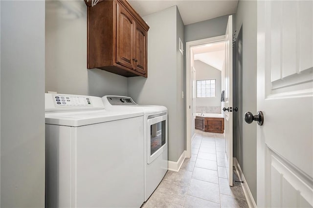 5021 NW Timberline Dr, Riverside, MO 64150 - washroom with washing machine and dryer, light tile patterned floors, cabinet space, and baseboards