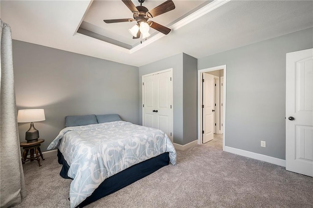 5021 NW Timberline Dr, Riverside, MO 64150 - carpeted bedroom featuring a tray ceiling, baseboards, a ceiling fan, and a closet