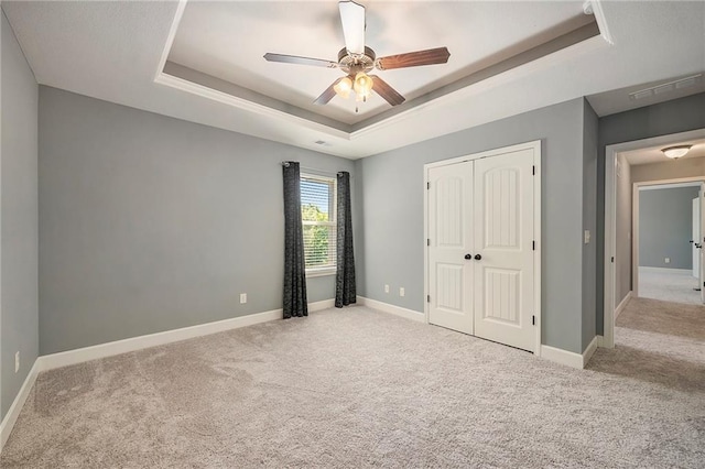 5021 NW Timberline Dr, Riverside, MO 64150 - unfurnished bedroom with a tray ceiling, carpet flooring, a closet, and baseboards