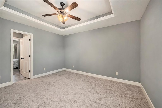 5021 NW Timberline Dr, Riverside, MO 64150 - empty room with carpet flooring, a raised ceiling, a ceiling fan, and baseboards