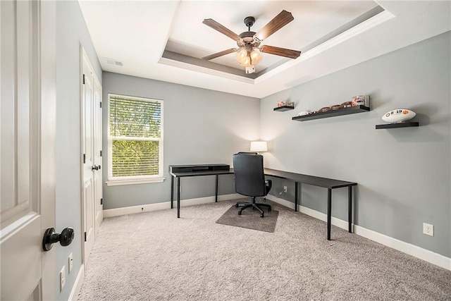 5021 NW Timberline Dr, Riverside, MO 64150 - carpeted office space featuring a tray ceiling, ceiling fan, and baseboards