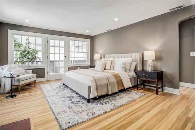 4804 Jarboe St, Kansas City, MO 64112 - bedroom featuring access to exterior, light wood finished floors, multiple windows, arched walkways, and recessed lighting