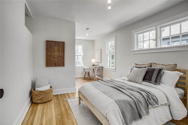 4804 Jarboe St, Kansas City, MO 64112 - bedroom featuring multiple windows, wood finished floors, baseboards, and recessed lighting